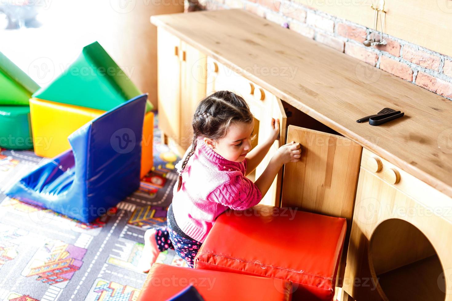 Rear view of a little girl opening wardrobe door photo