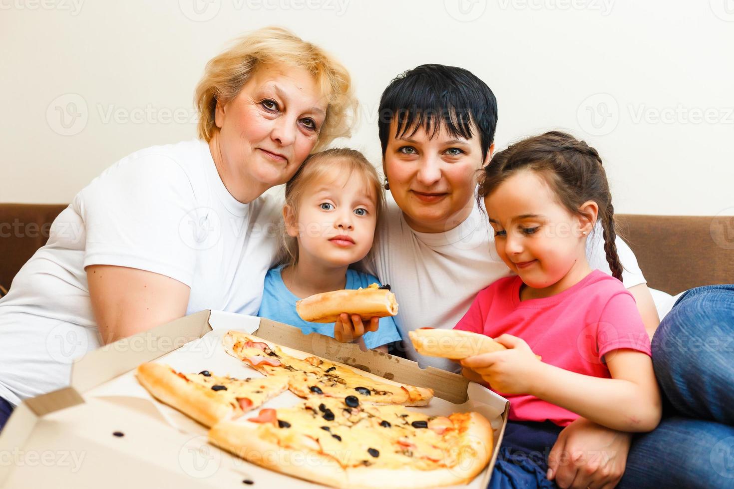 Family Eating Pizza Together at home photo