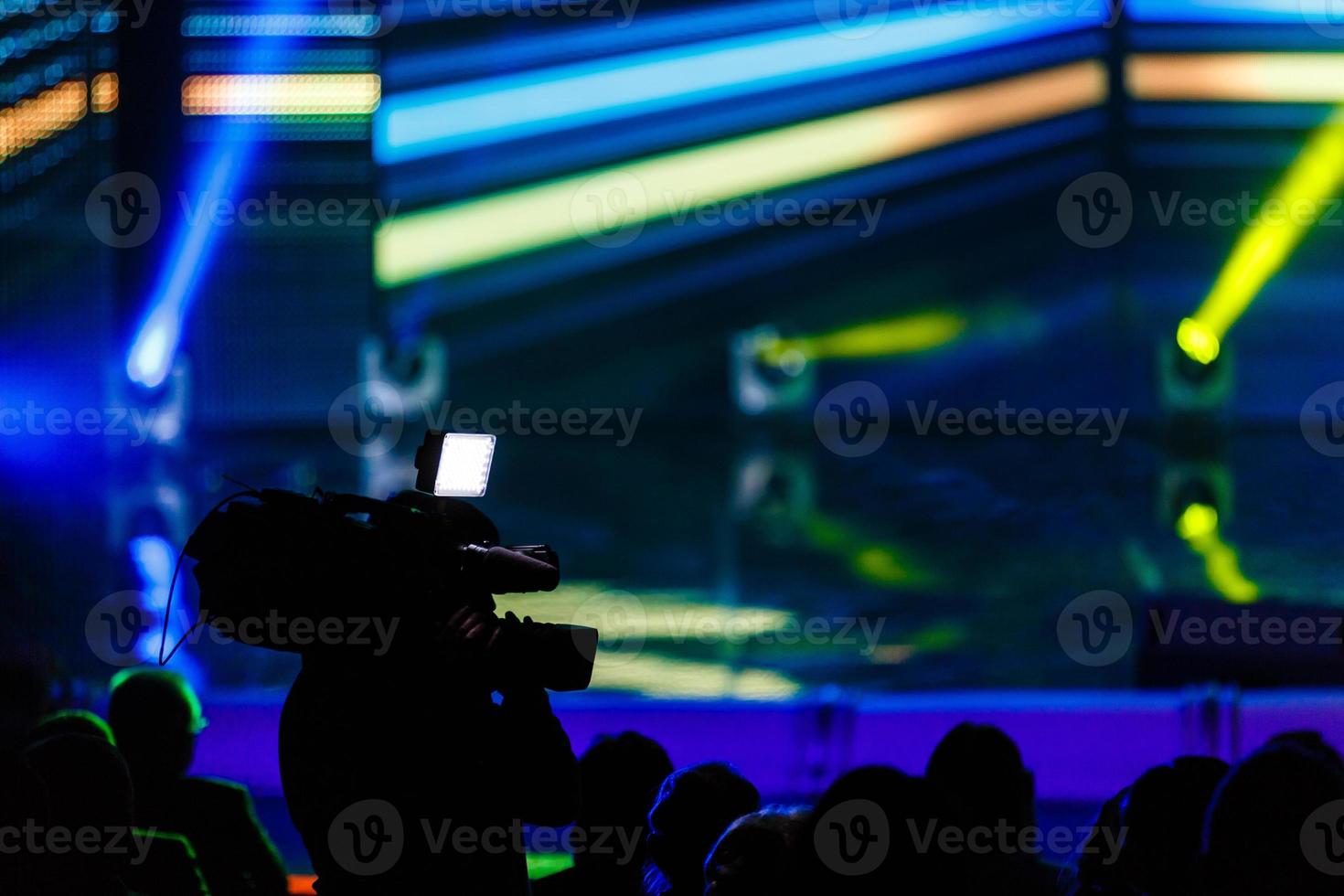 the camcorder shoots the scene with a yellow background photo