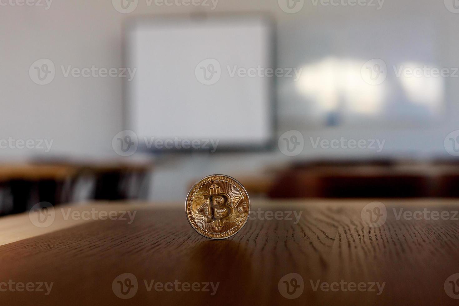 Single bitcoin coin in wooden desk close up photo
