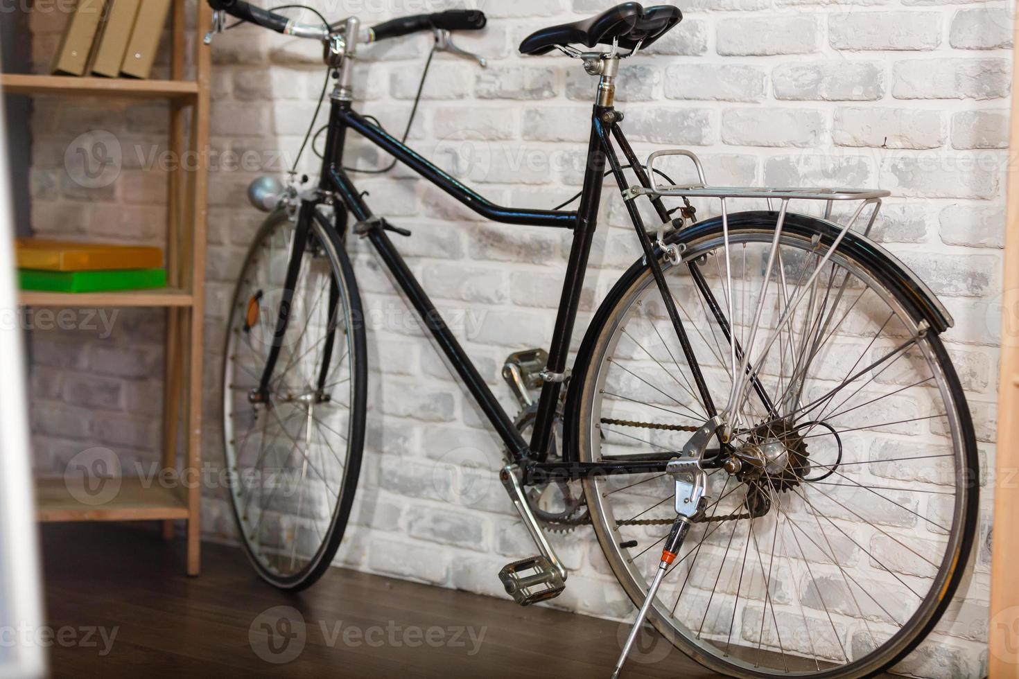 Bike in a room against wall photo
