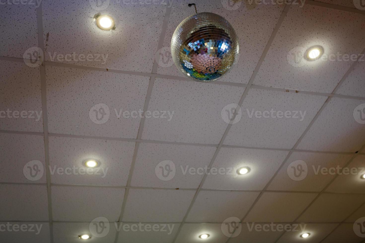 Disco ball hanging from the ceilings close up view vintage film look