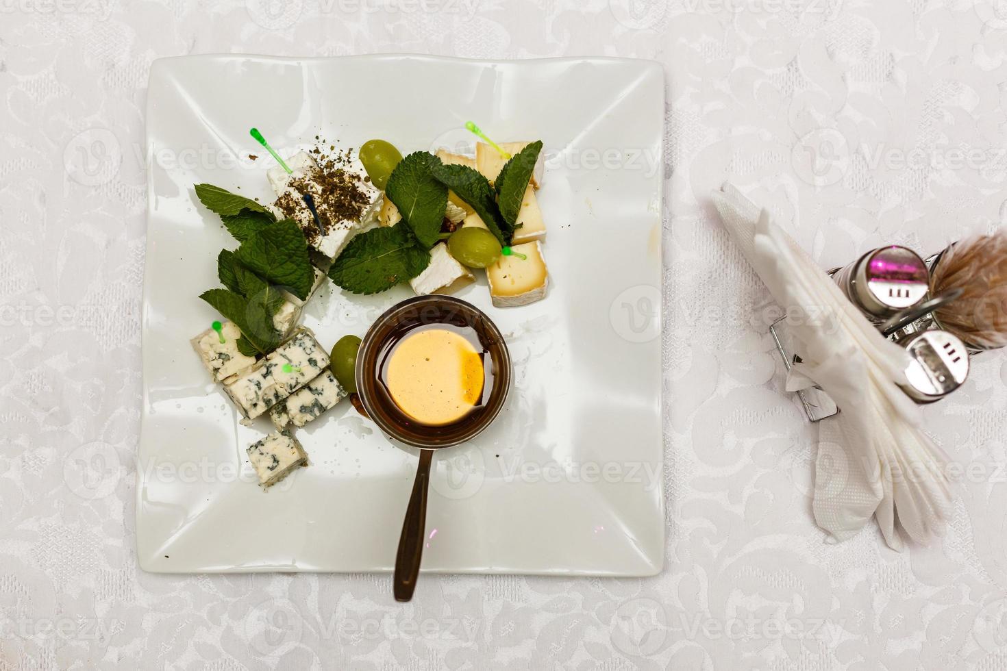 Cheese plate with different kinds of cheese with thyme herbs and walnuts photo