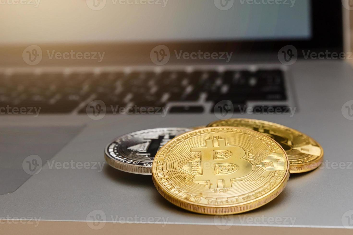 Golden bitcoins on laptop trading concept of crypto currency photo
