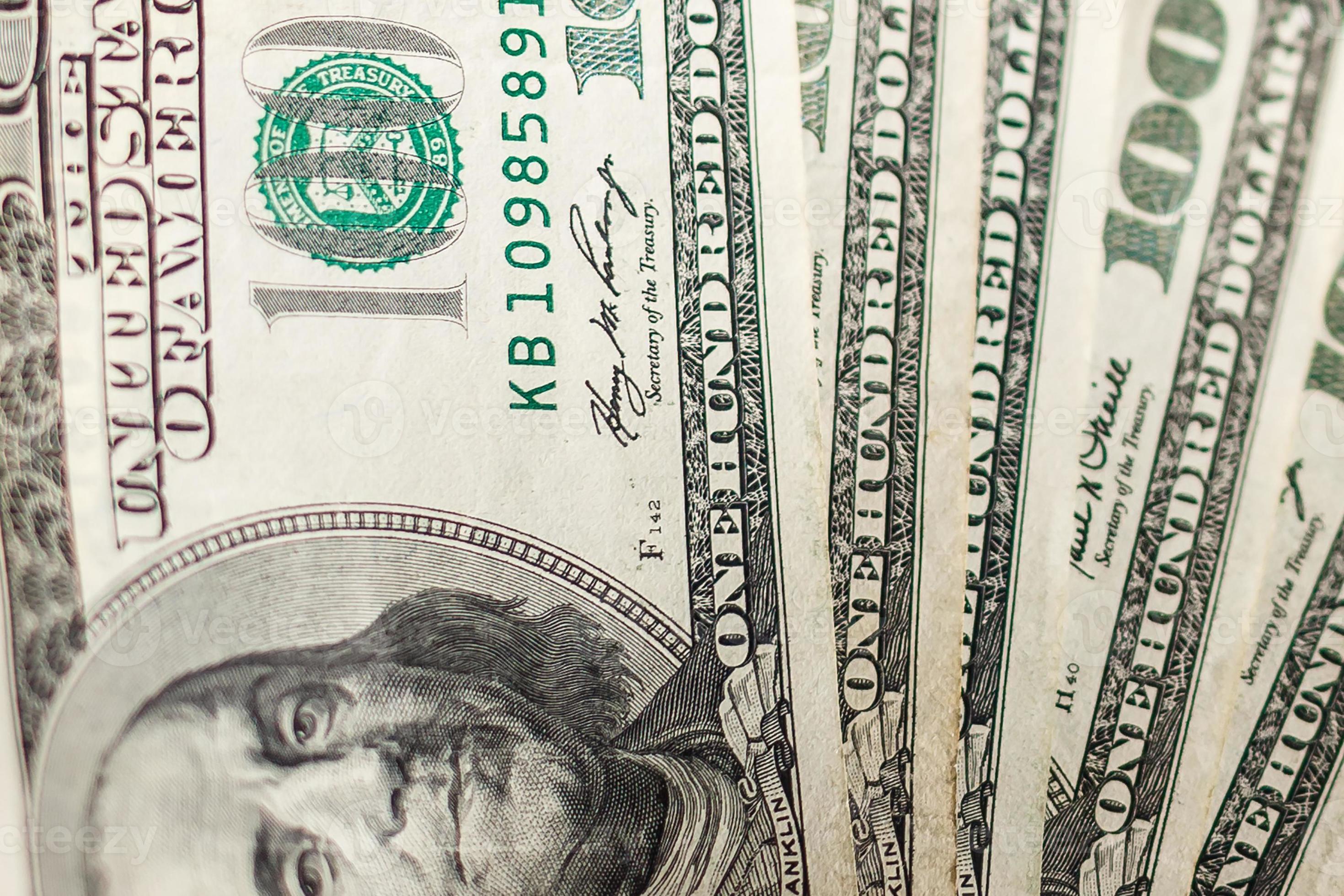 Close up of a man s hand crushing a wad of hundred dollar bills in concept of getting money with