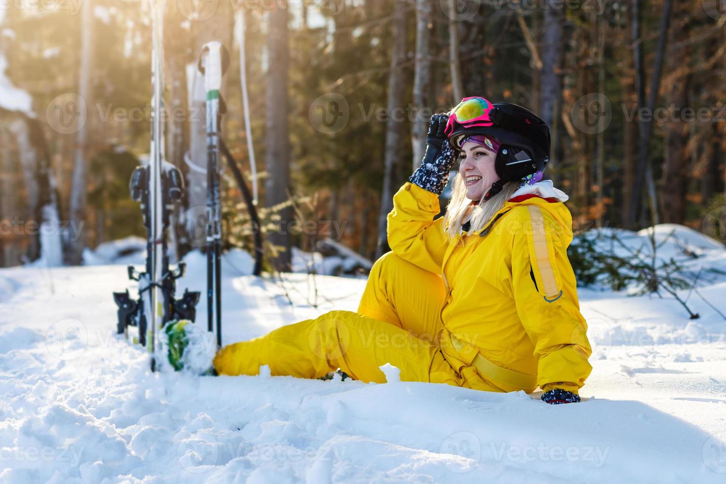 Ski. Funny female skier on the background of high snow-capped photo