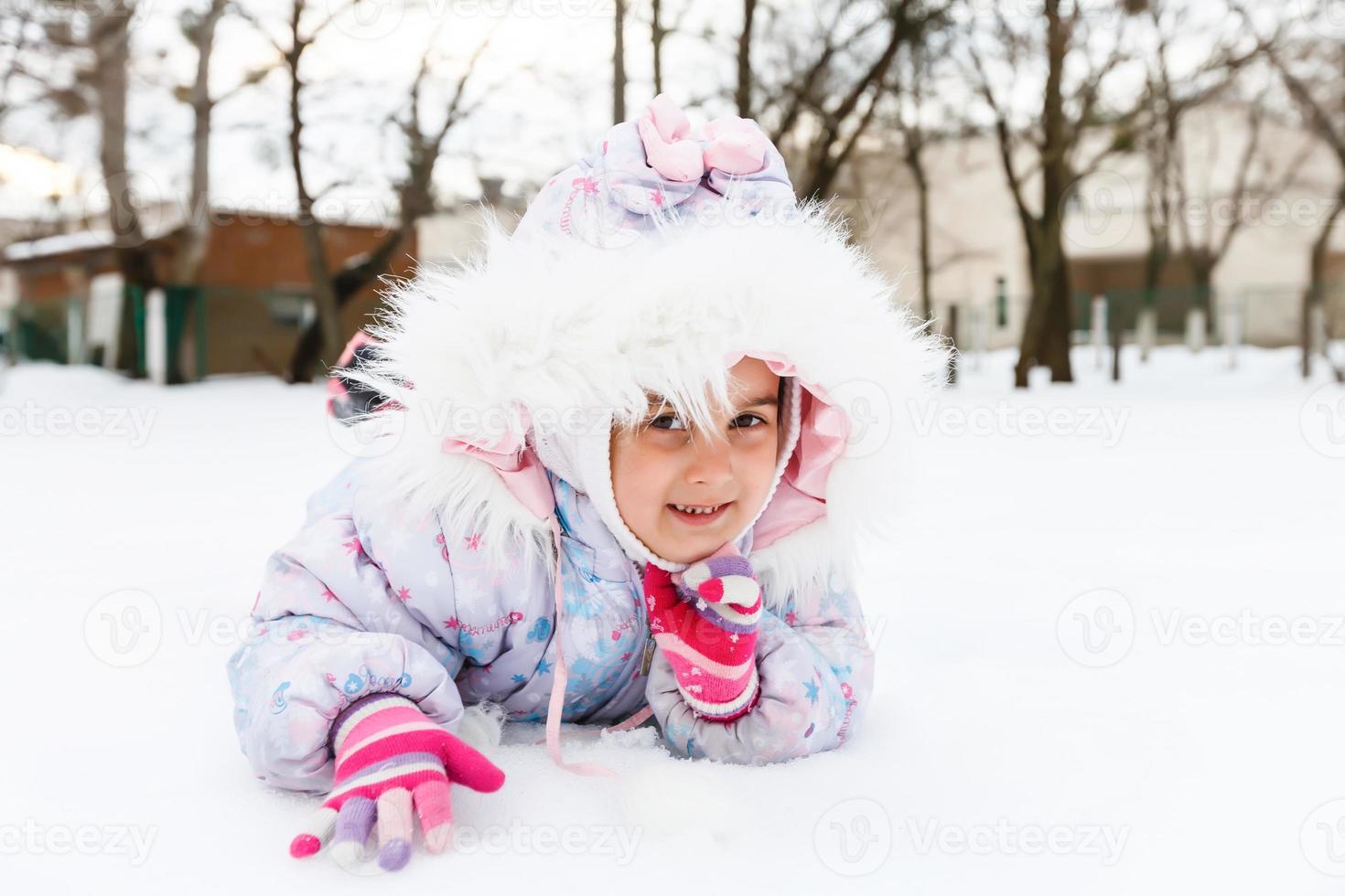 Portrait of a little girl smiling in the snow photo