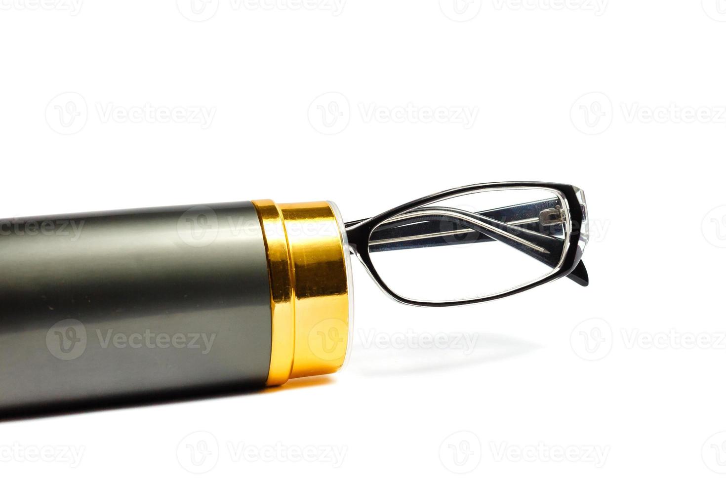 Classic glasses in a metal frame and gold case on a white background space for text photo