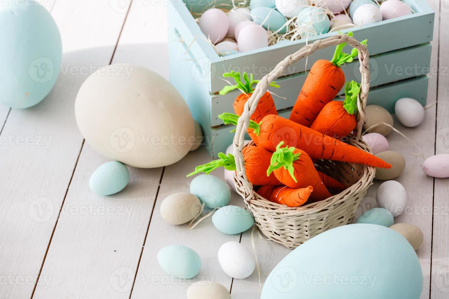 Easter eggs in nest on color wooden background photo