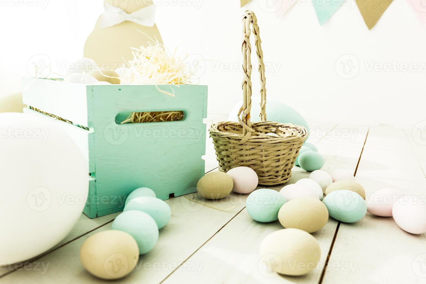 Easter Many colorful Easter eggs with bunnies and baskets decoration of the room, childrens room for games. Basket with carrots and rabbits. Easter photo shoot.
