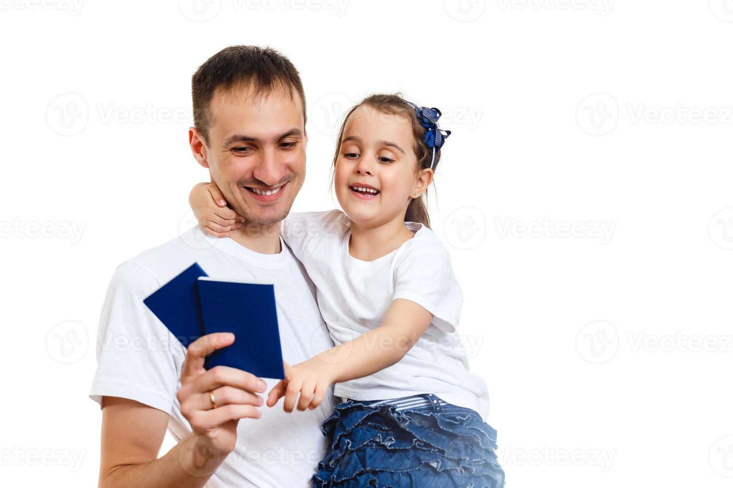 Travel concept studio portrait of pretty young dad with hands up holding passport with tickets photo