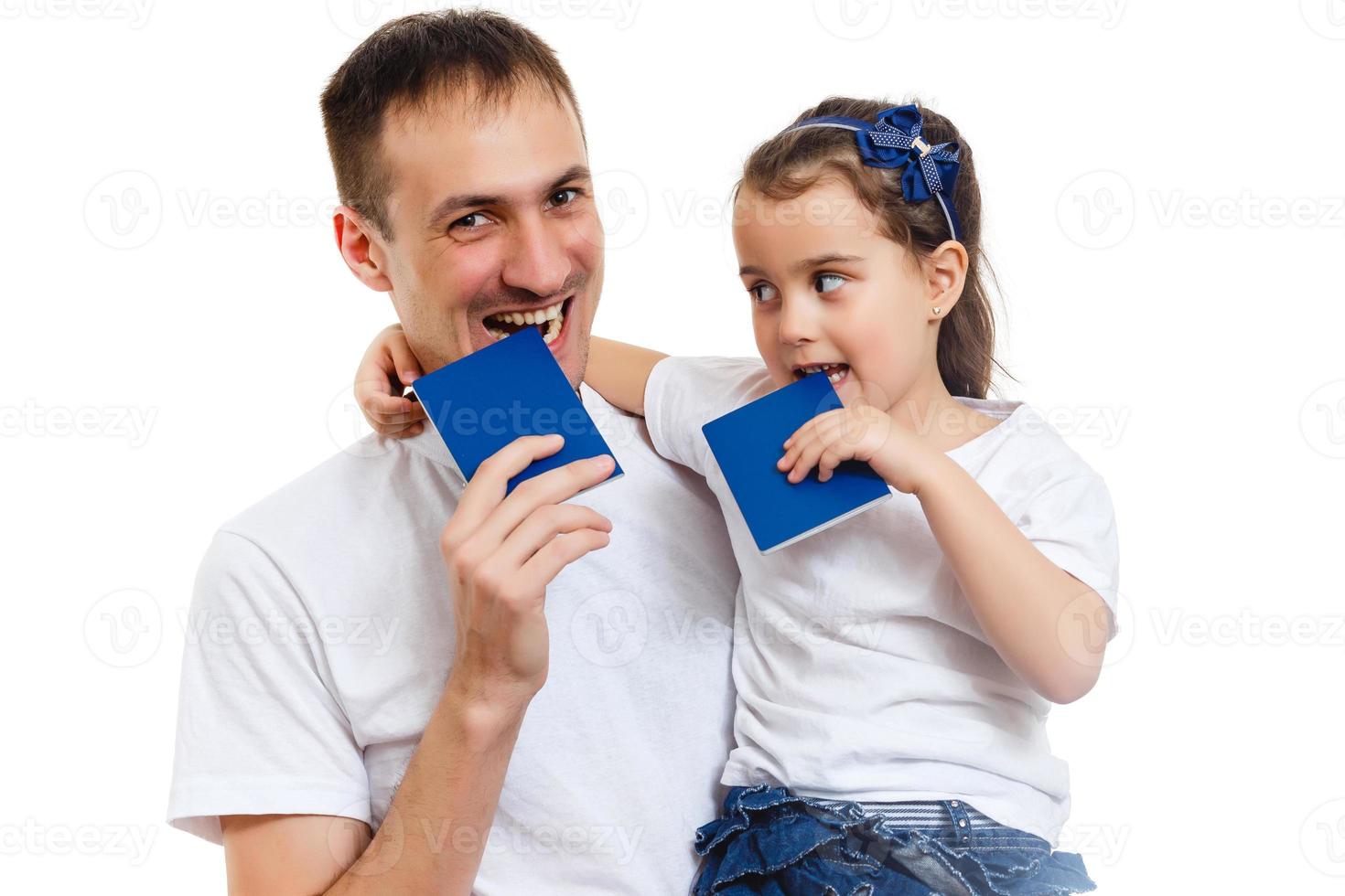 Travel concept studio portrait of pretty young dad with hands up holding passport with tickets photo