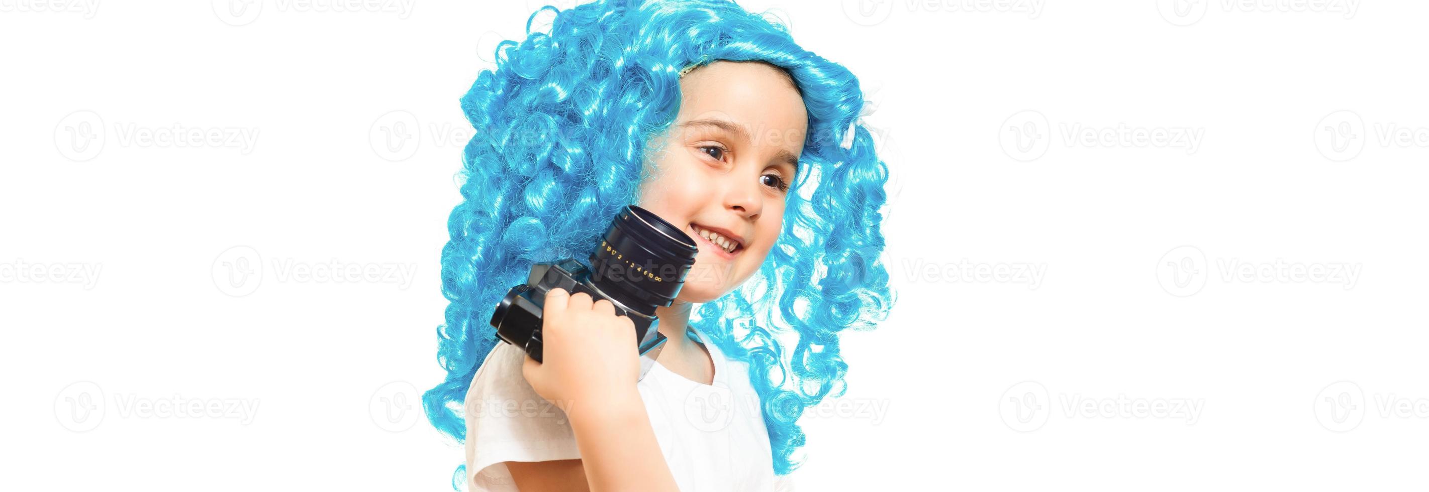 Funky style beauty. Cute baby with long blue hair. Small child wear blue wig hair. Small kid in fancy wig hairstyle. Adorable little child in fashion wig. Beauty look hairstyle for cosplay party. photo