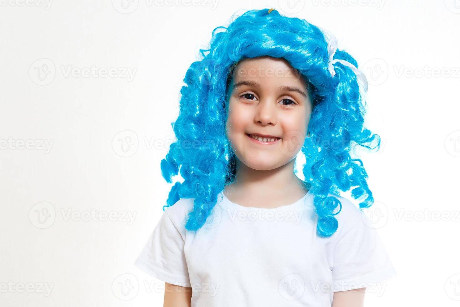 Beautiful little girl dressed up like a doll with turquoise hair isolated on white photo