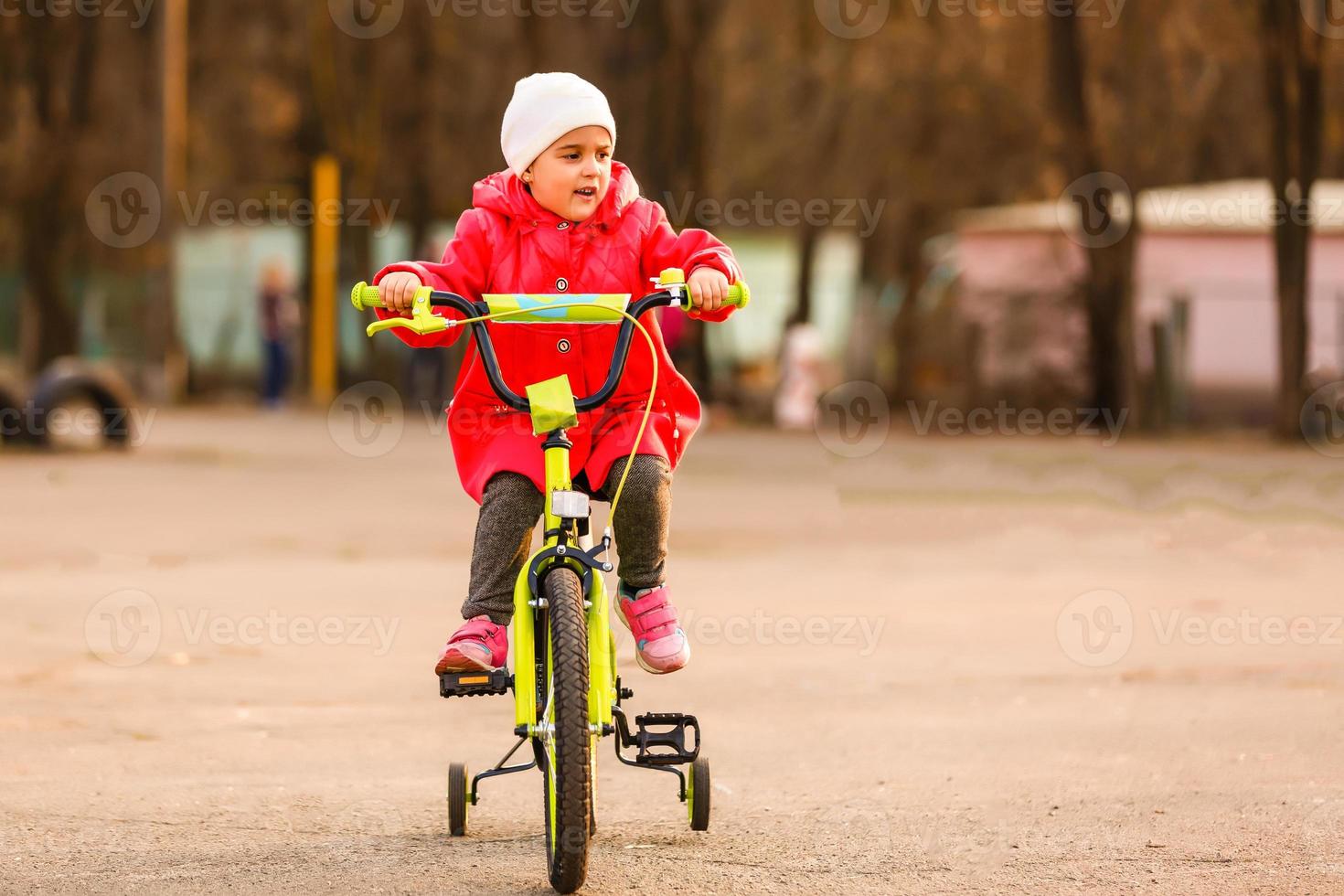 Little girl with her bicycle photo