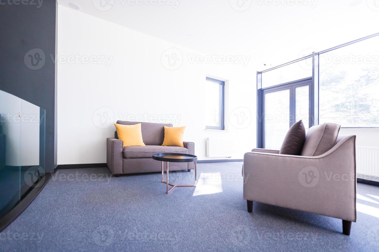 A set of office furniture near windows photo