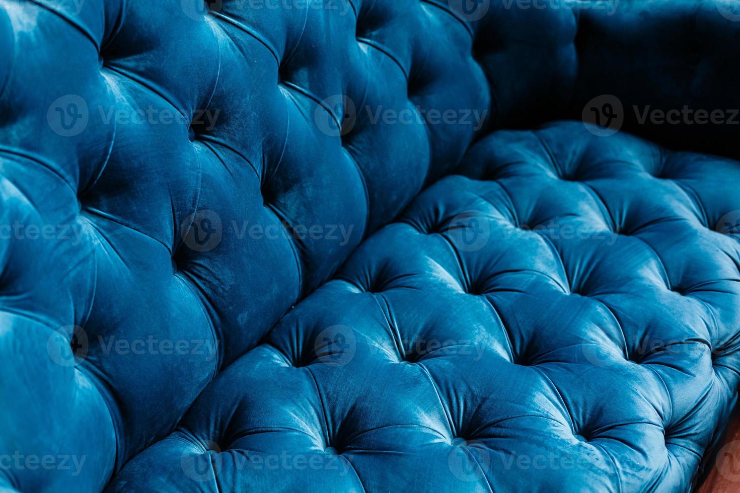 Velvet couch background texture with sunken buttons photo