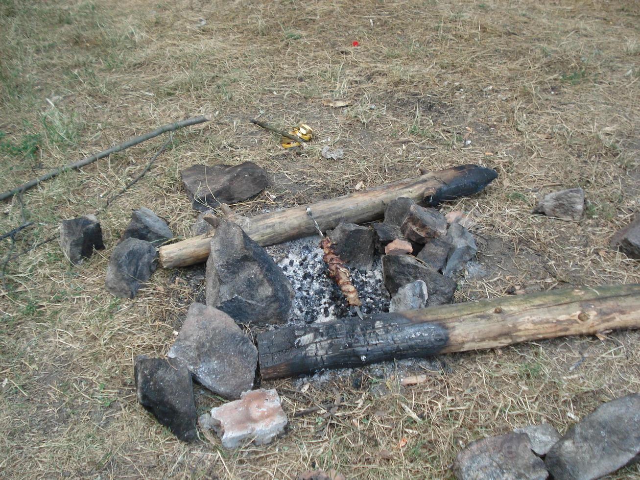 Cooking meat on skewers in the woods on the coals. The view from the top. photo
