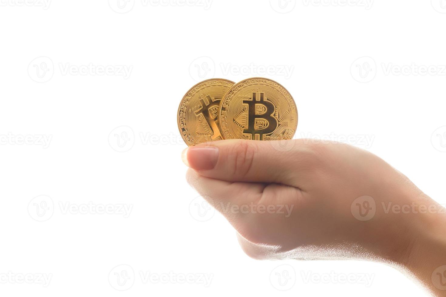Two golden bitcoin in  hand digitall symbol of a new virtual currency isolated on white photo