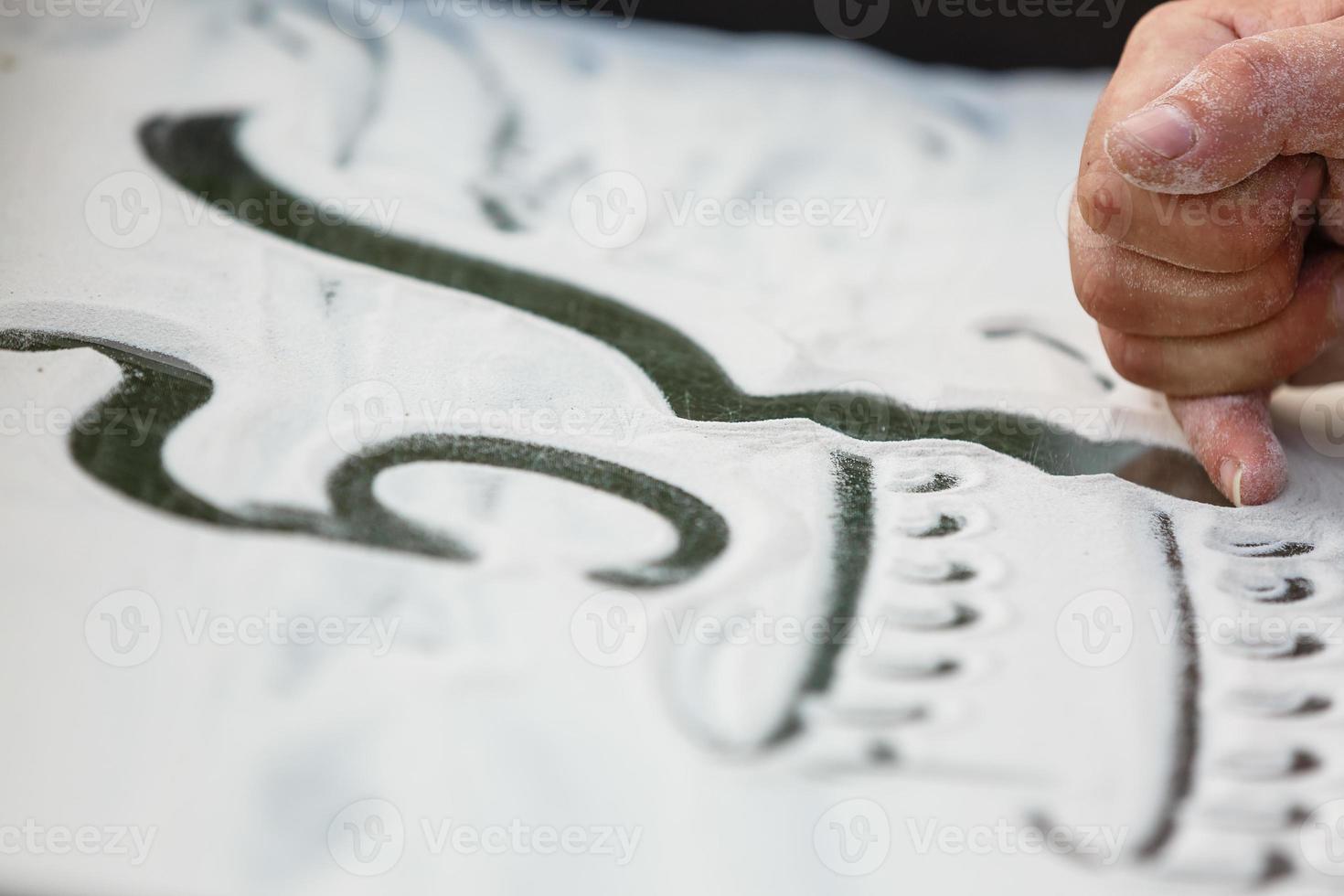 Sand animation. Hands draw sand photo