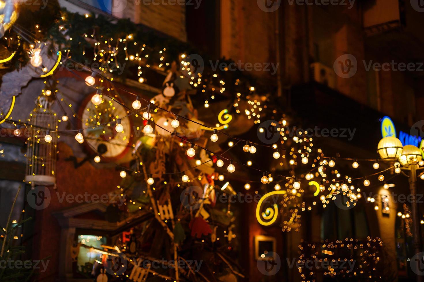 Garlands of lamps on a wooden stand on the street. A wedding Banquet. photo