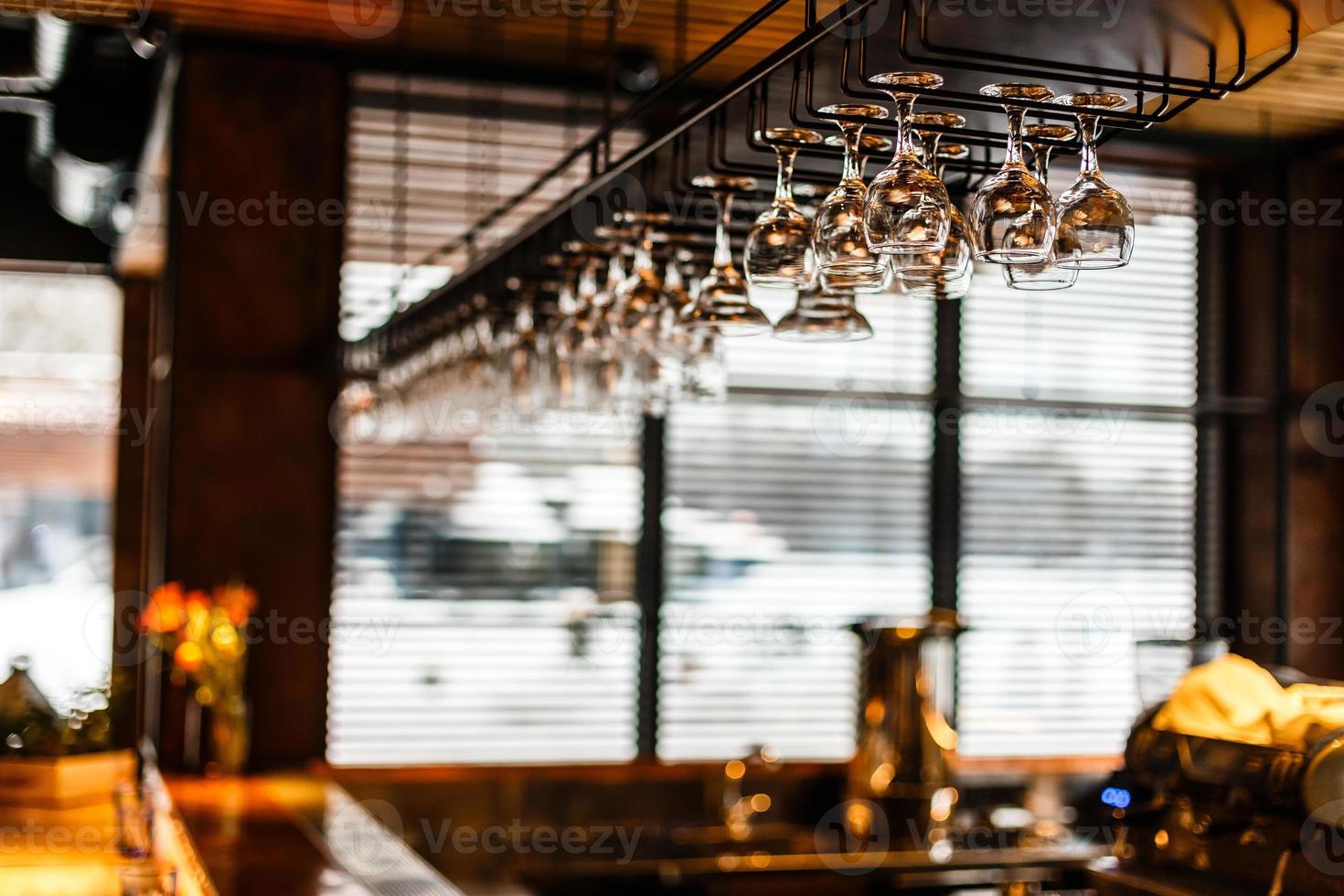 different glasses hanging over the bar. Soft focus photo