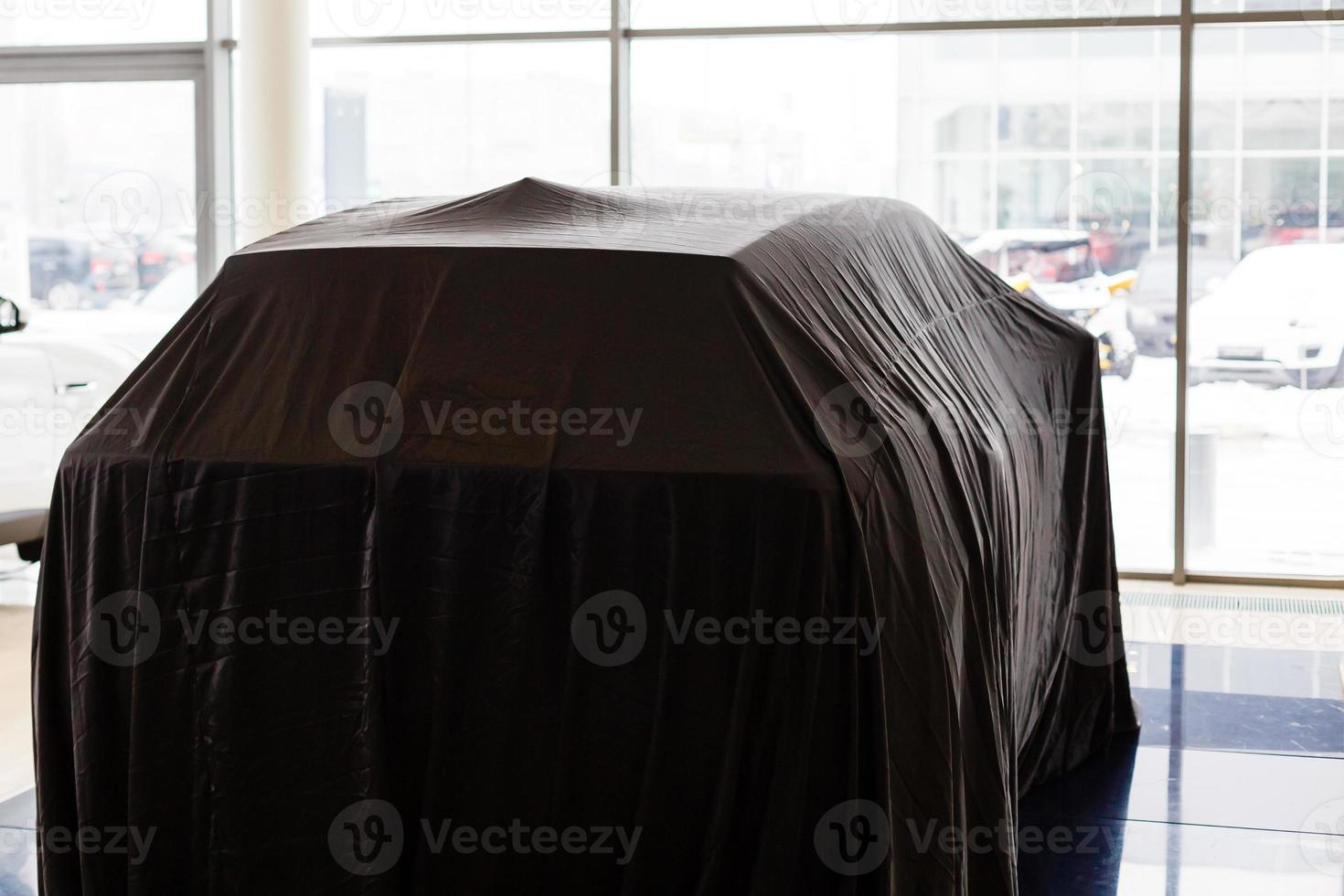 close up of a new car hidden under cover photo