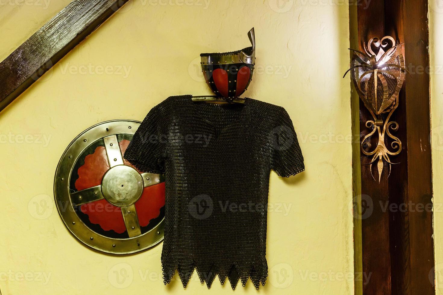 knight armor with swords on wooden wall in castle photo