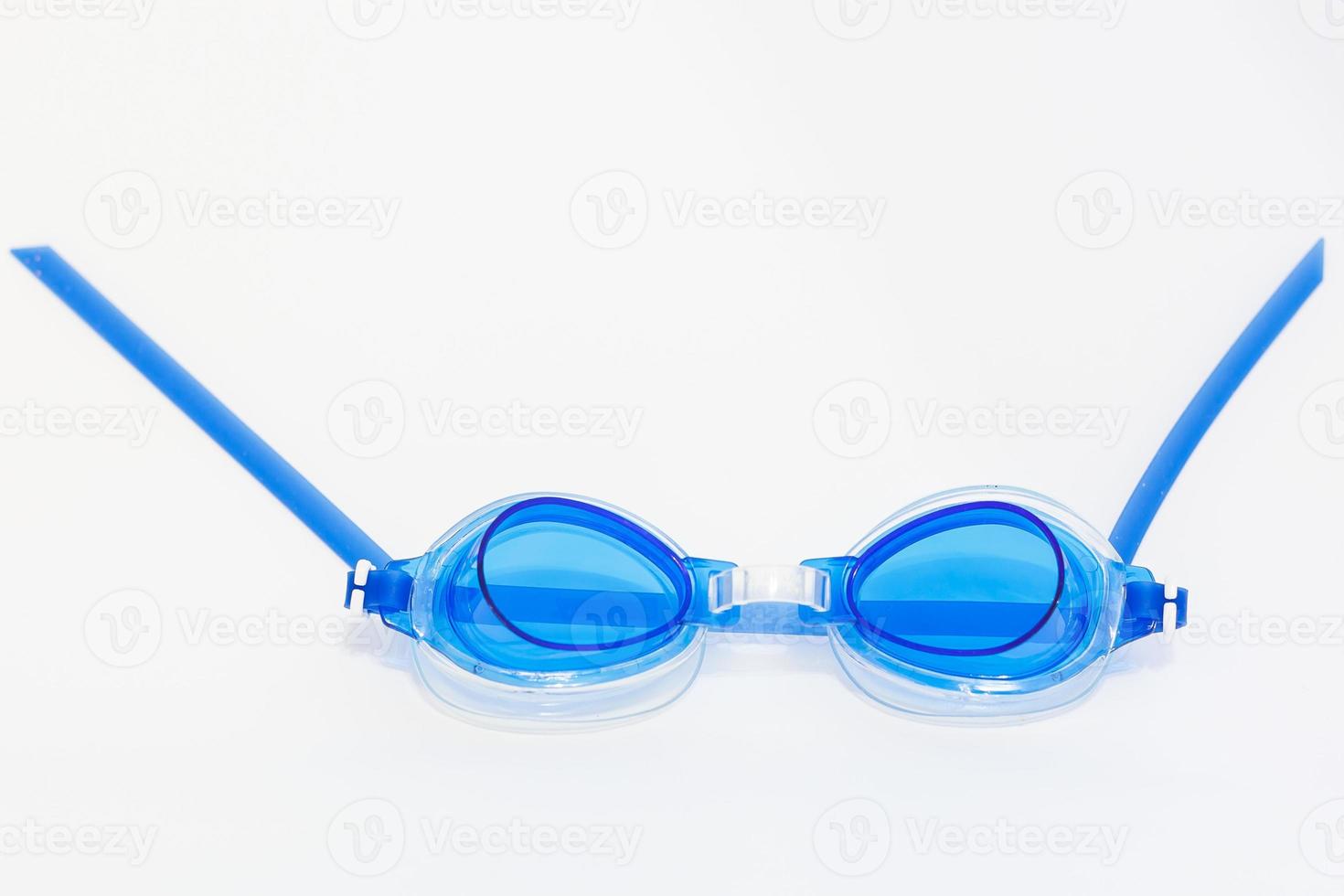 Blue goggles for swimming with water drops isolated on white background photo