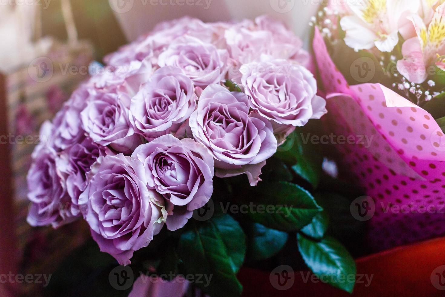 Purple roses in a wedding arrangement photo