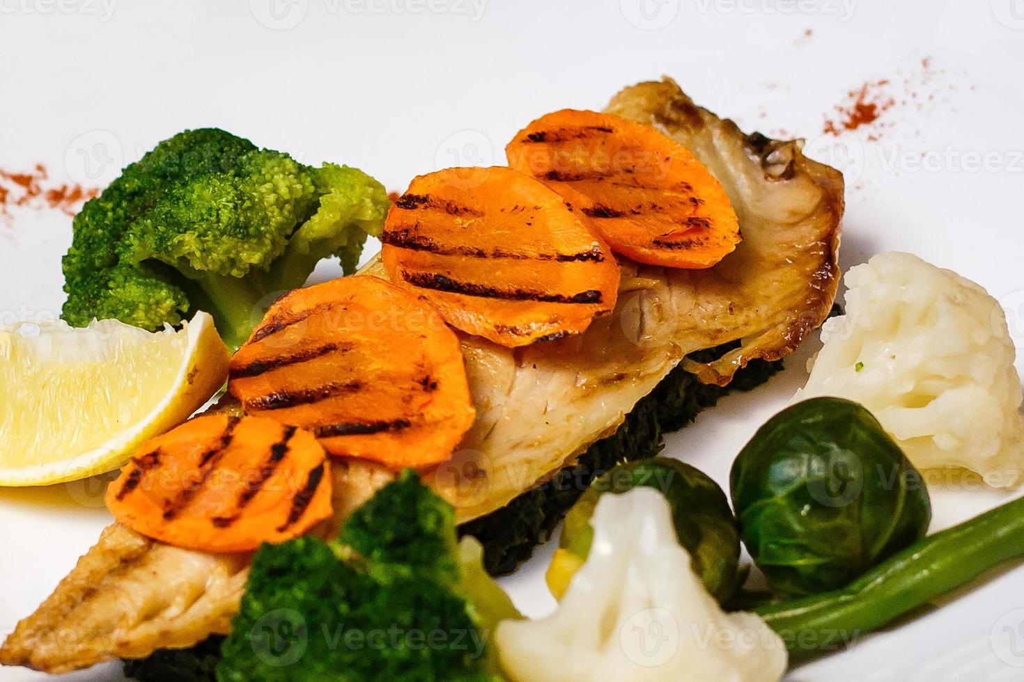 Baked mackerel fish stuffed with carrots. Top flat view. Close-up. photo