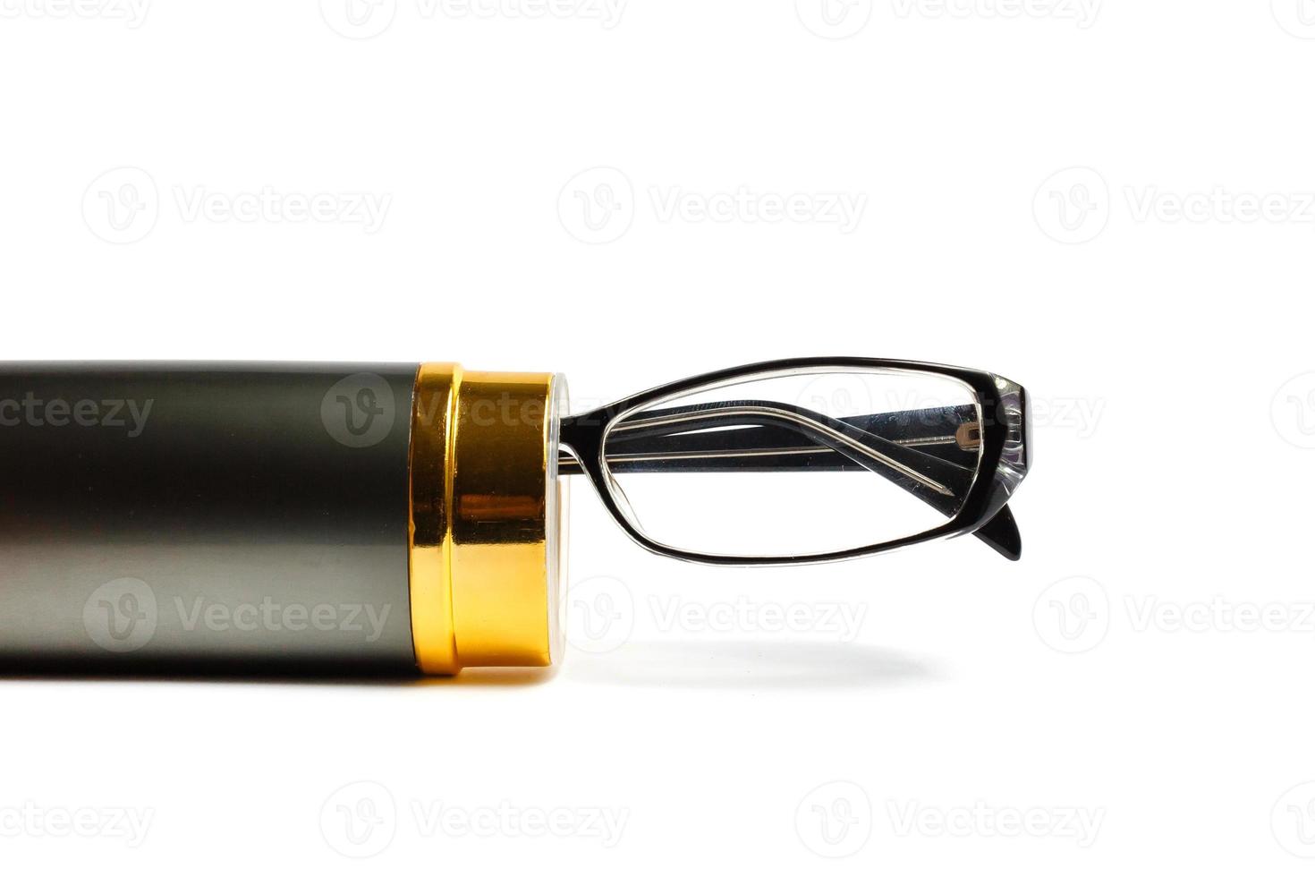 Classic glasses in a metal frame and gold case on a white background space for text photo