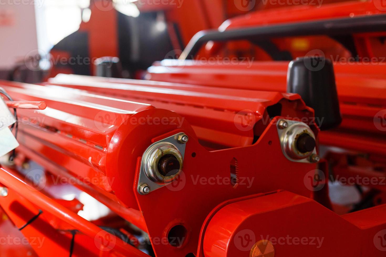 Close up of pipe system of hydraulic valves in agricultural machinery photo