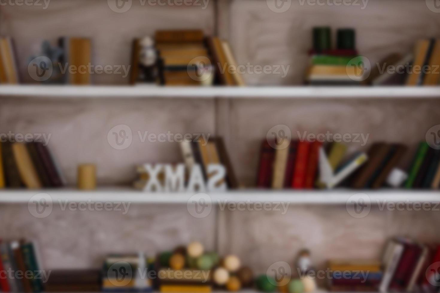 Blurred image many old books on bookshelf in library photo