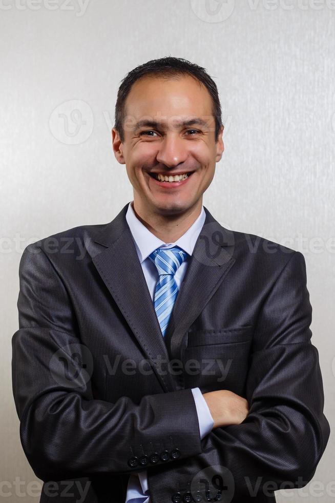 Young and attractive businessman standing against a white background wearing a jacket photo