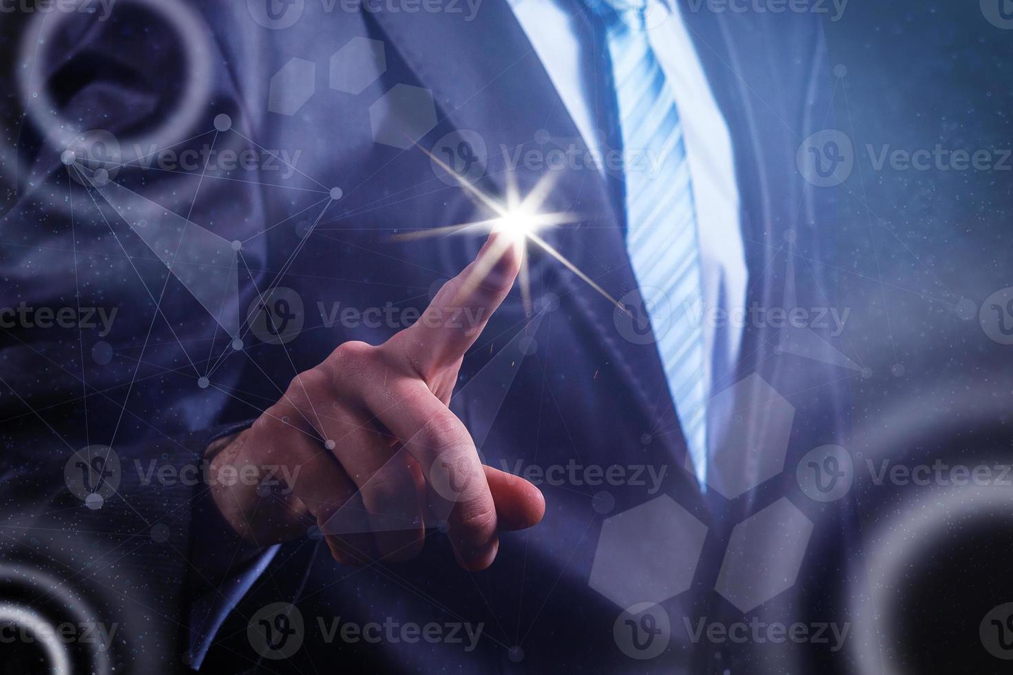 Close up of businessman touching digital screen with finger photo