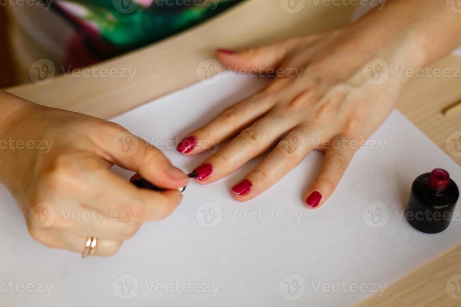 A woman doing manicure focus on her hands photo