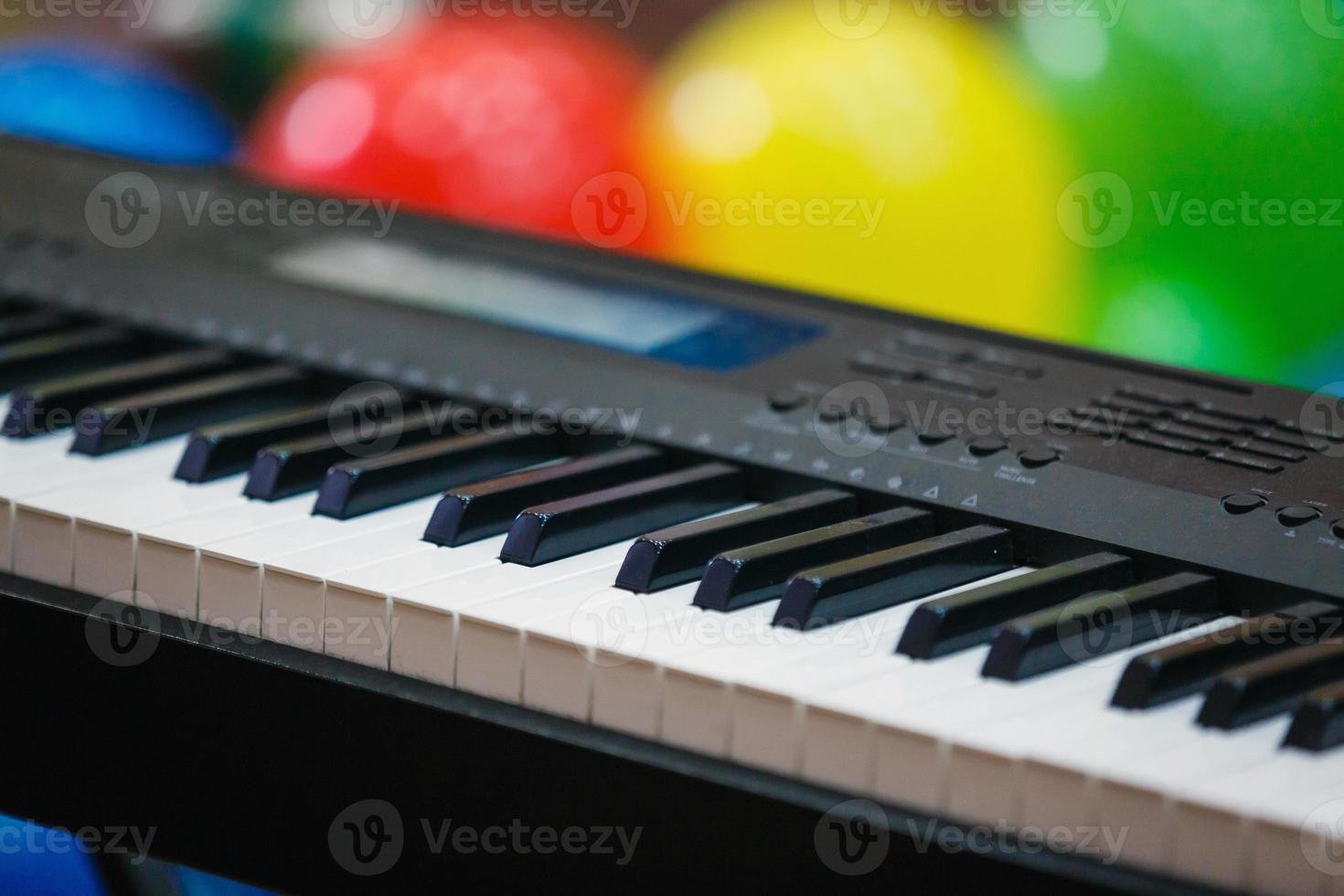 Synthesizer piano piano keys close up blurred background colorful bokeh musical instruments photo