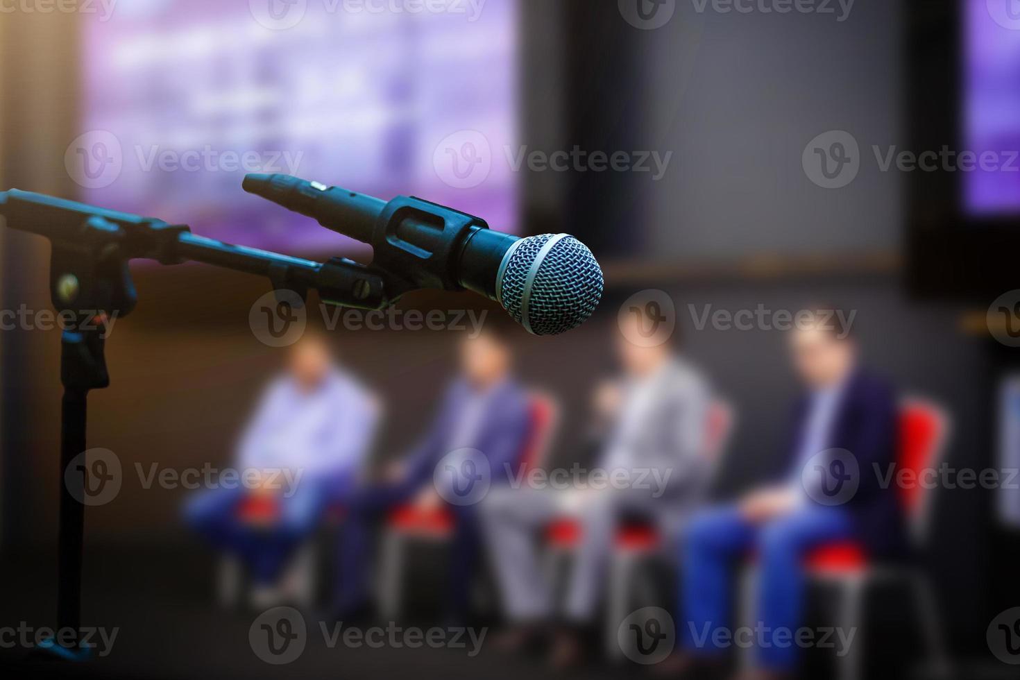 Microphone in front businesspeople blurred in conference meeting room photo