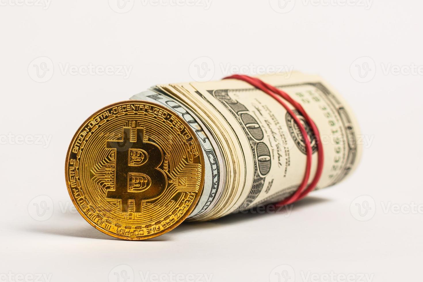 bitcoin is on the pack of dollars is twisted into a roll photo
