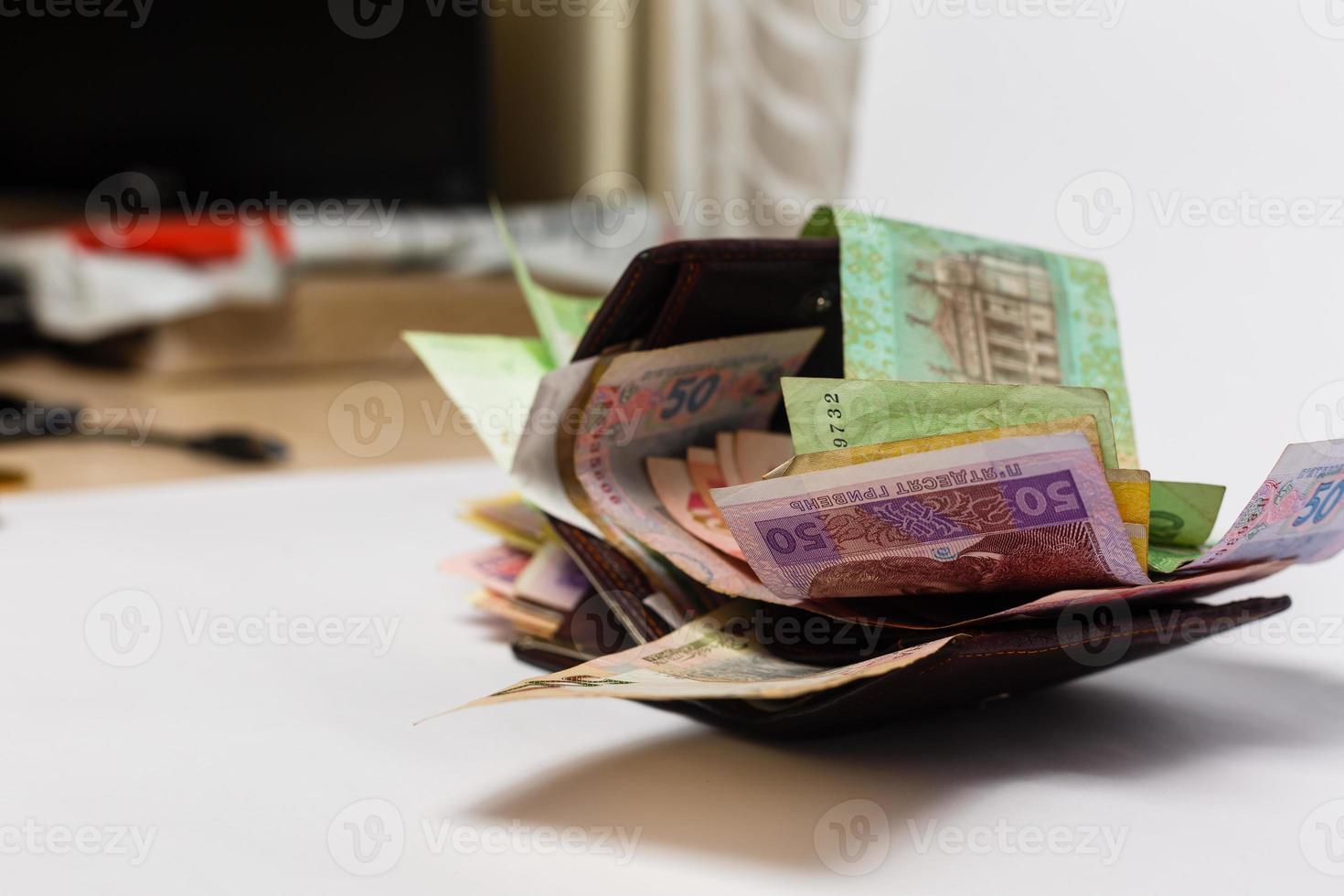 Ukrainian hryvnia banknotes in denominations in black purse isolated photo