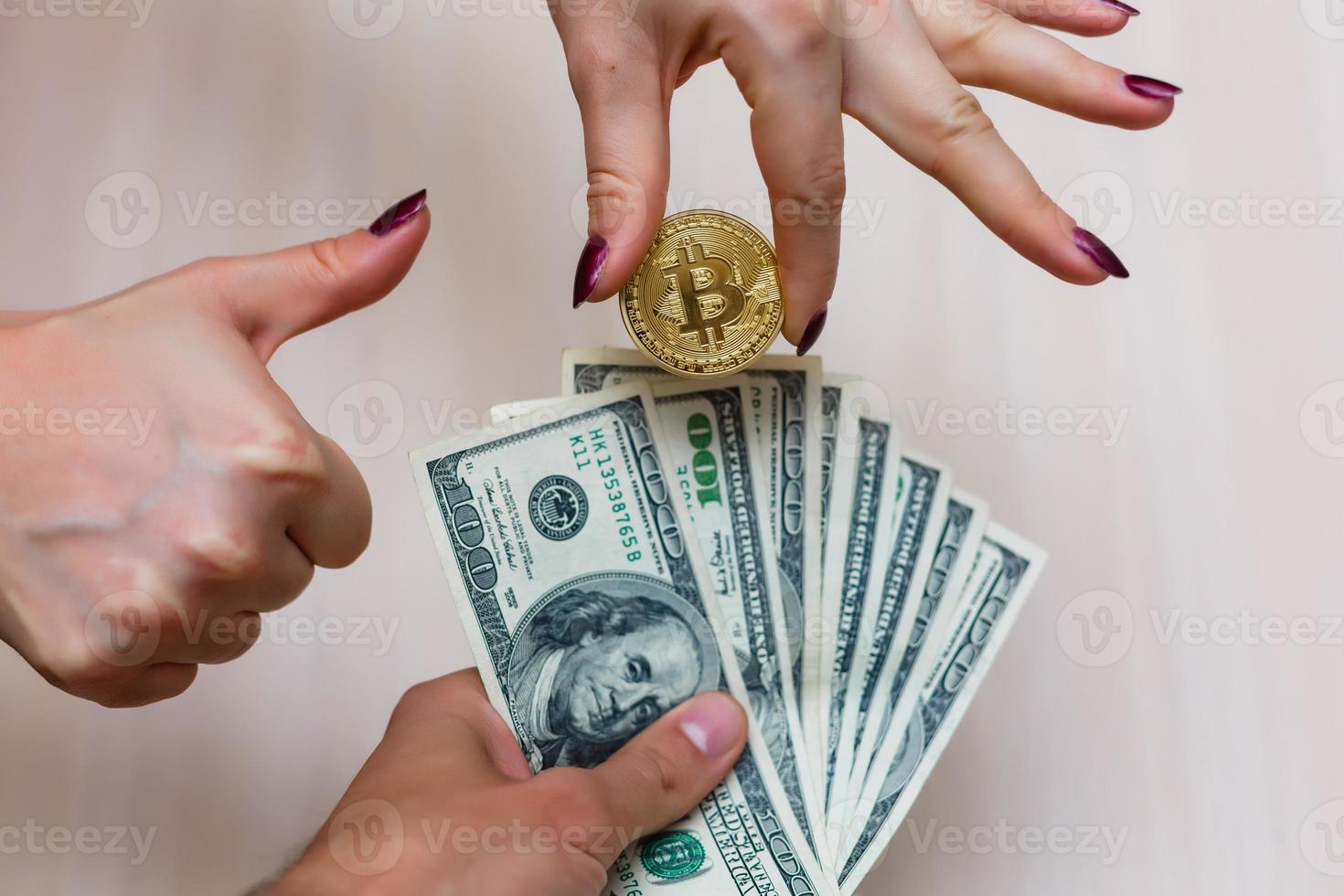 Golden bitcoins on us dollars in the hands electronic money exchange concept photo