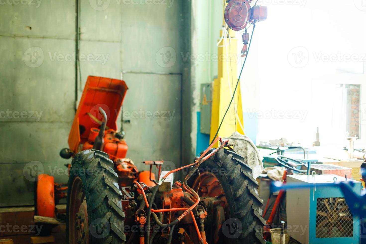 Tractor engine rear view oil machinery technology industry manufacturing wires steel tire photo