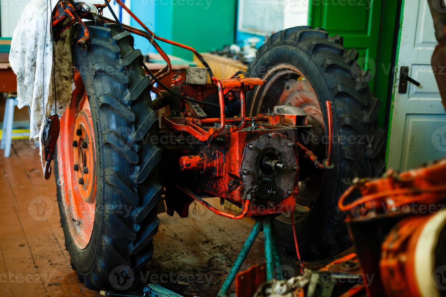 Tractor engine rear view oil machinery technology industry manufacturing wires steel tire photo