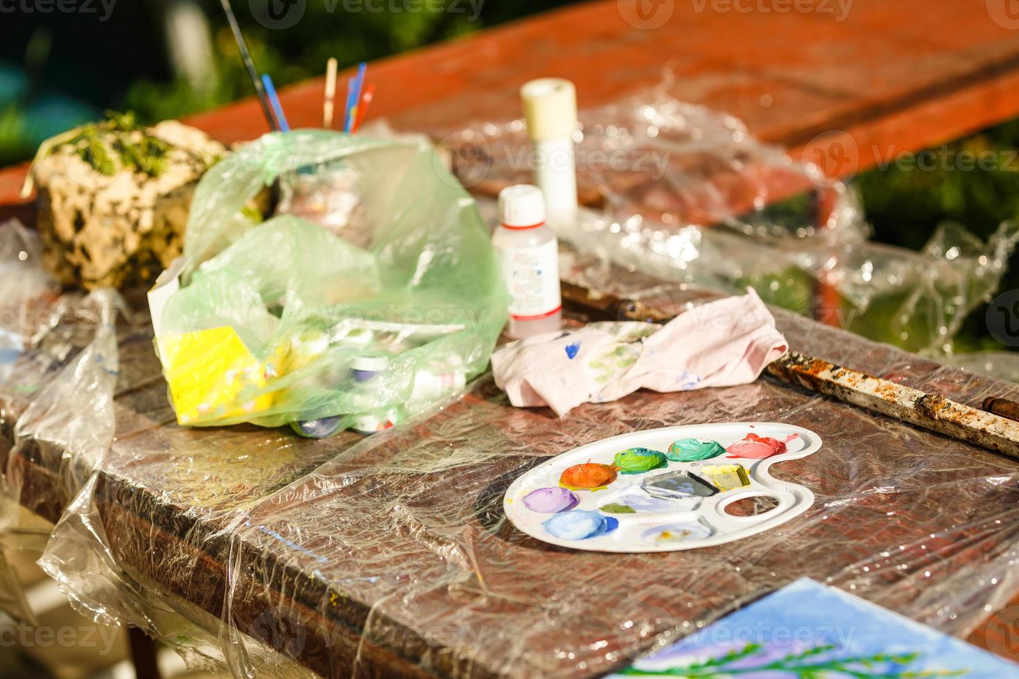 Flat lay composition with paint cans, brushes and color palettes on wooden background photo