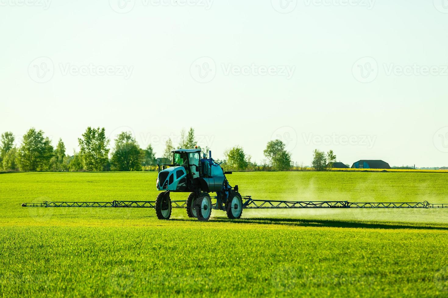 In the agricultural enterprise self-propelled sprayer with GPS-navigation herbicides handle spring field photo