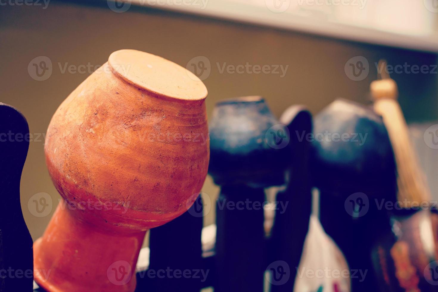 Landscape design clay pitchers pitchers on a woven wooden fence photo