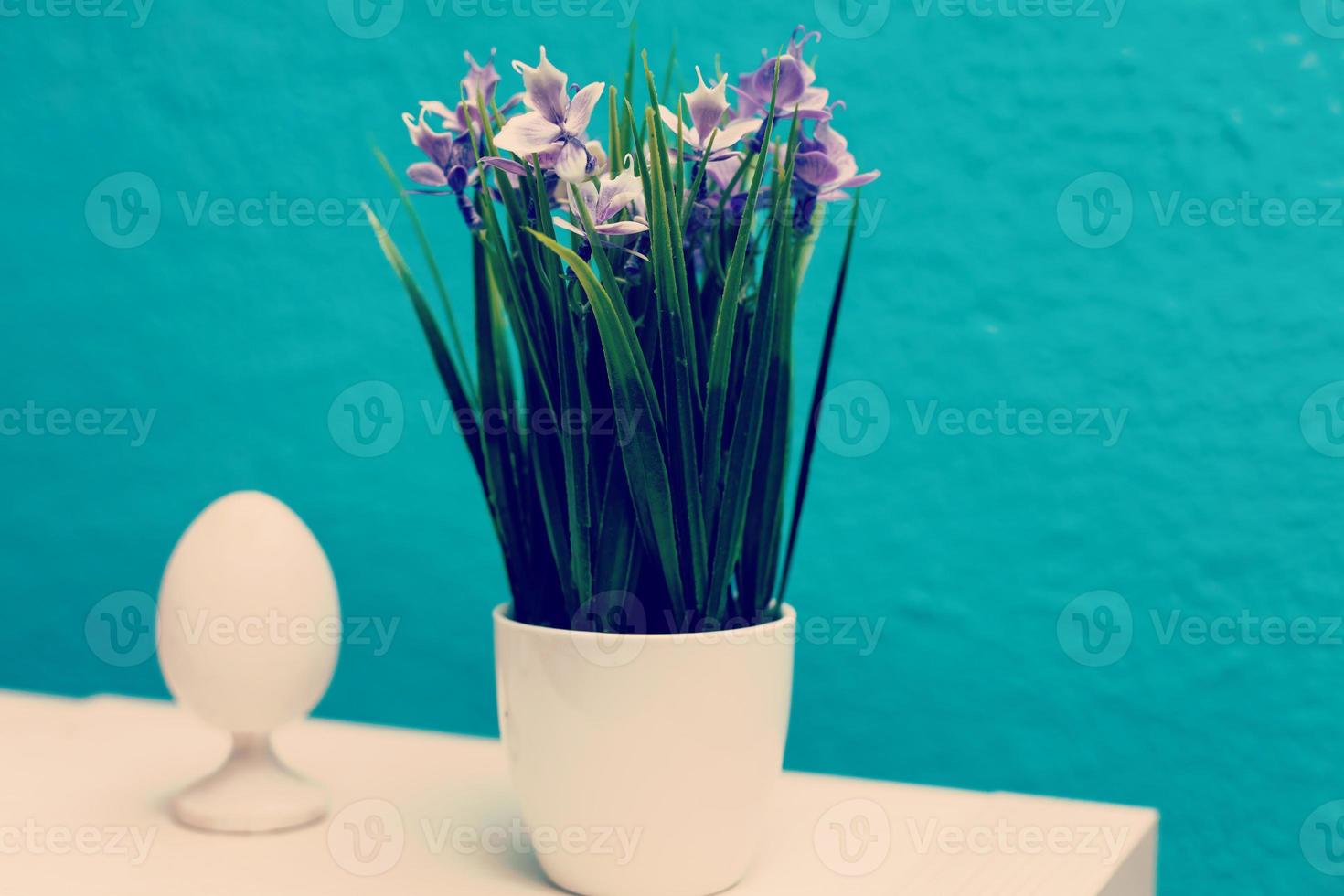 Easter egg on grass in a white ceramic flowerpot easter decorations photo