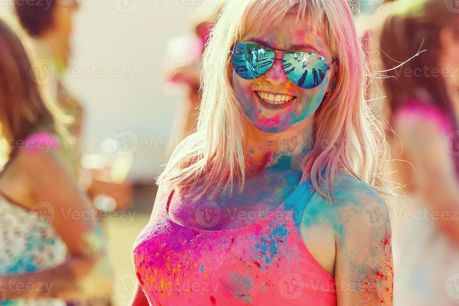 Portrait of happy girl on Holi color festival photo