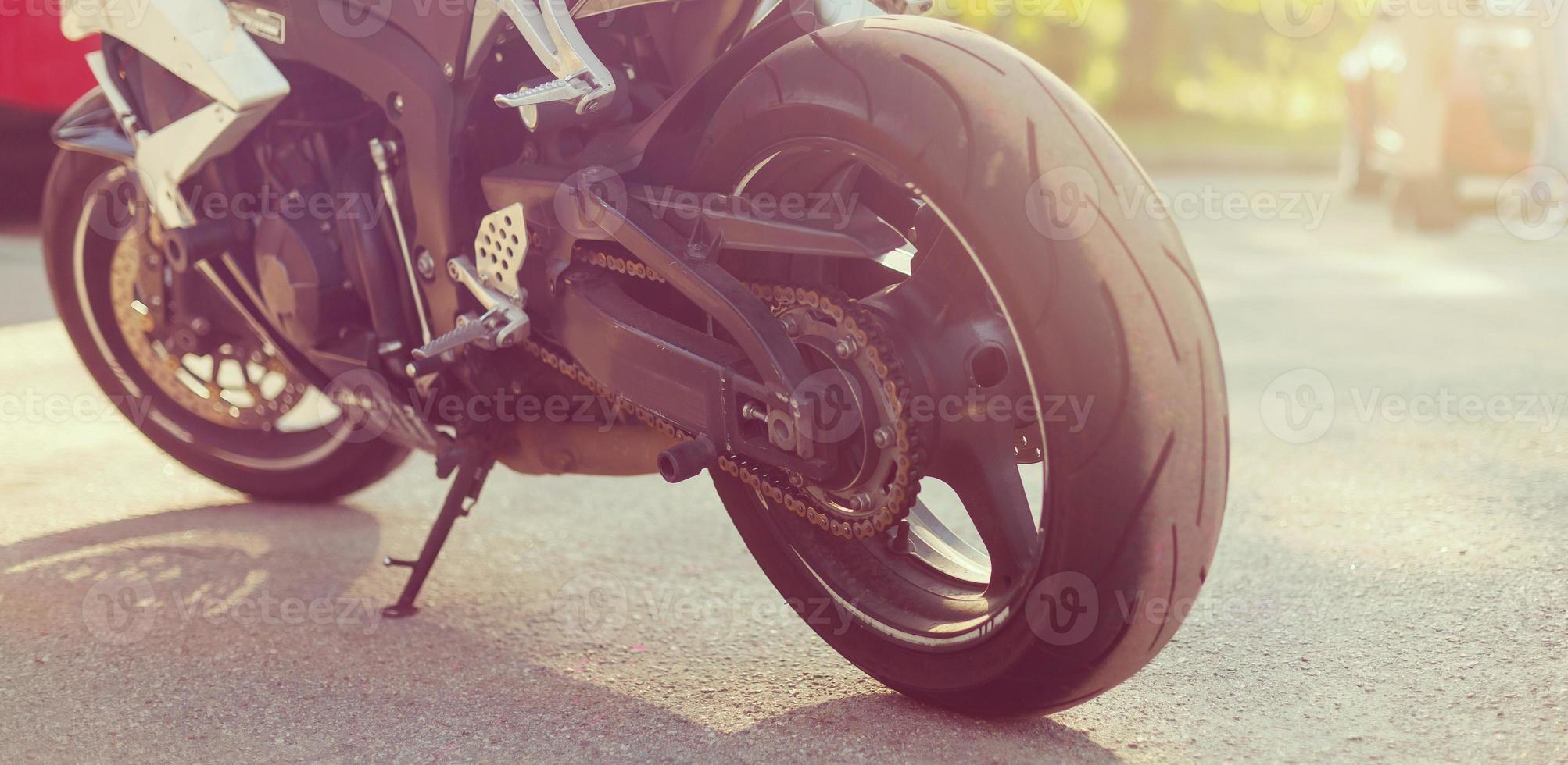 A motorcycle parking on the road right side and sunset, select focusing background. photo